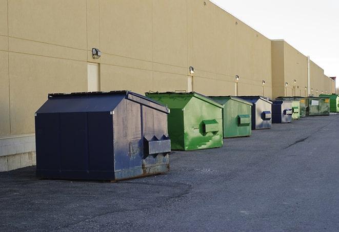 a series of colorful, utilitarian dumpsters deployed in a construction site in Bunnell